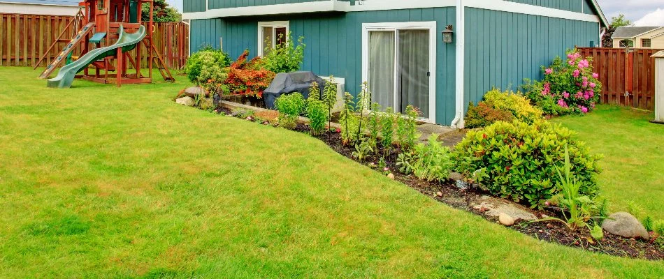 Manicured lawn and neat landscaping on a property in Ada, MI.